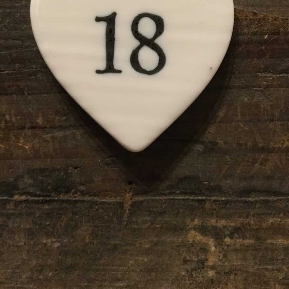 East Of India: Small White Porcelain Hanging Heart with Birthday Number in Black Writing: 18