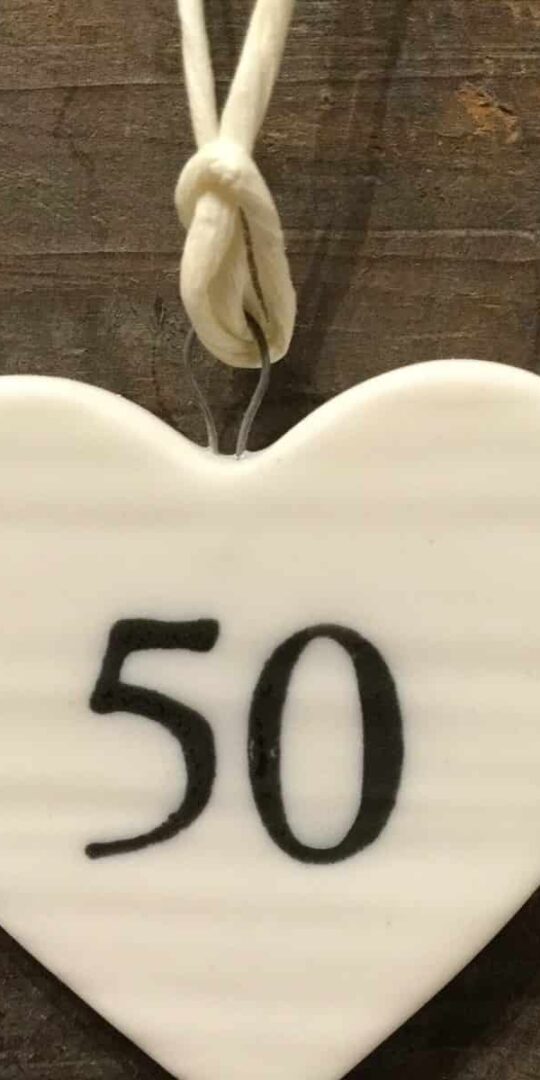 East Of India: Small White Porcelain Hanging Heart with Birthday Number in Black Writing: 50
