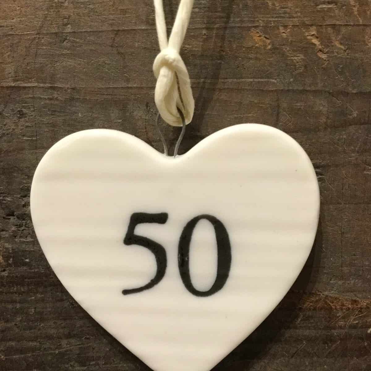 East Of India: Small White Porcelain Hanging Heart with Birthday Number in Black Writing: 50