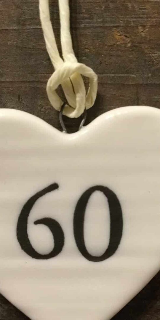 East Of India: Small White Porcelain Hanging Heart with Birthday Number in Black Writing: 60