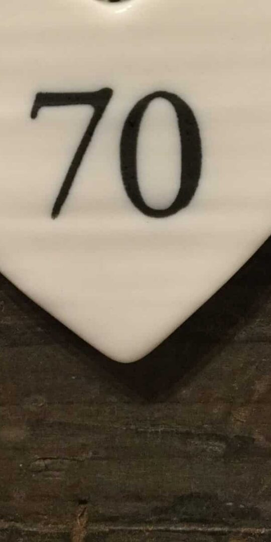 East Of India: Small White Porcelain Hanging Heart with Birthday Number in Black Writing: 70