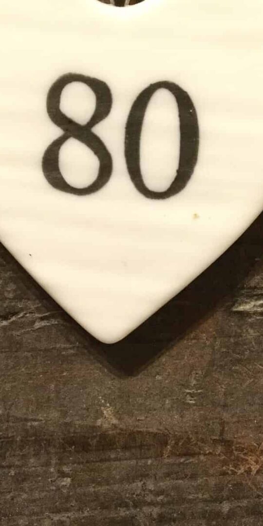 East Of India: Small White Porcelain Hanging Heart with Birthday Number in Black Writing: 80
