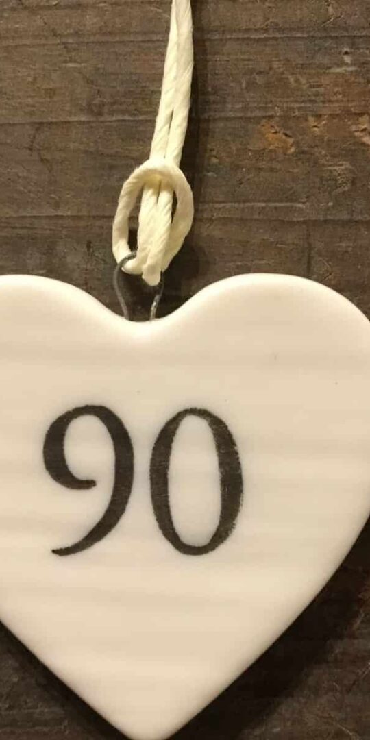 East Of India: Small White Porcelain Hanging Heart with Birthday Number in Black Writing: 90