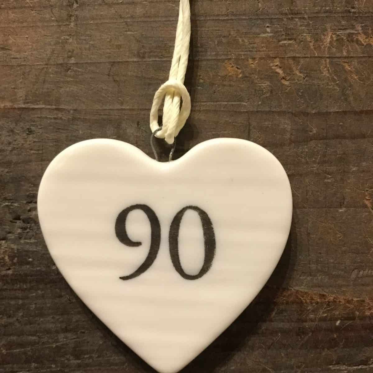 East Of India: Small White Porcelain Hanging Heart with Birthday Number in Black Writing: 90