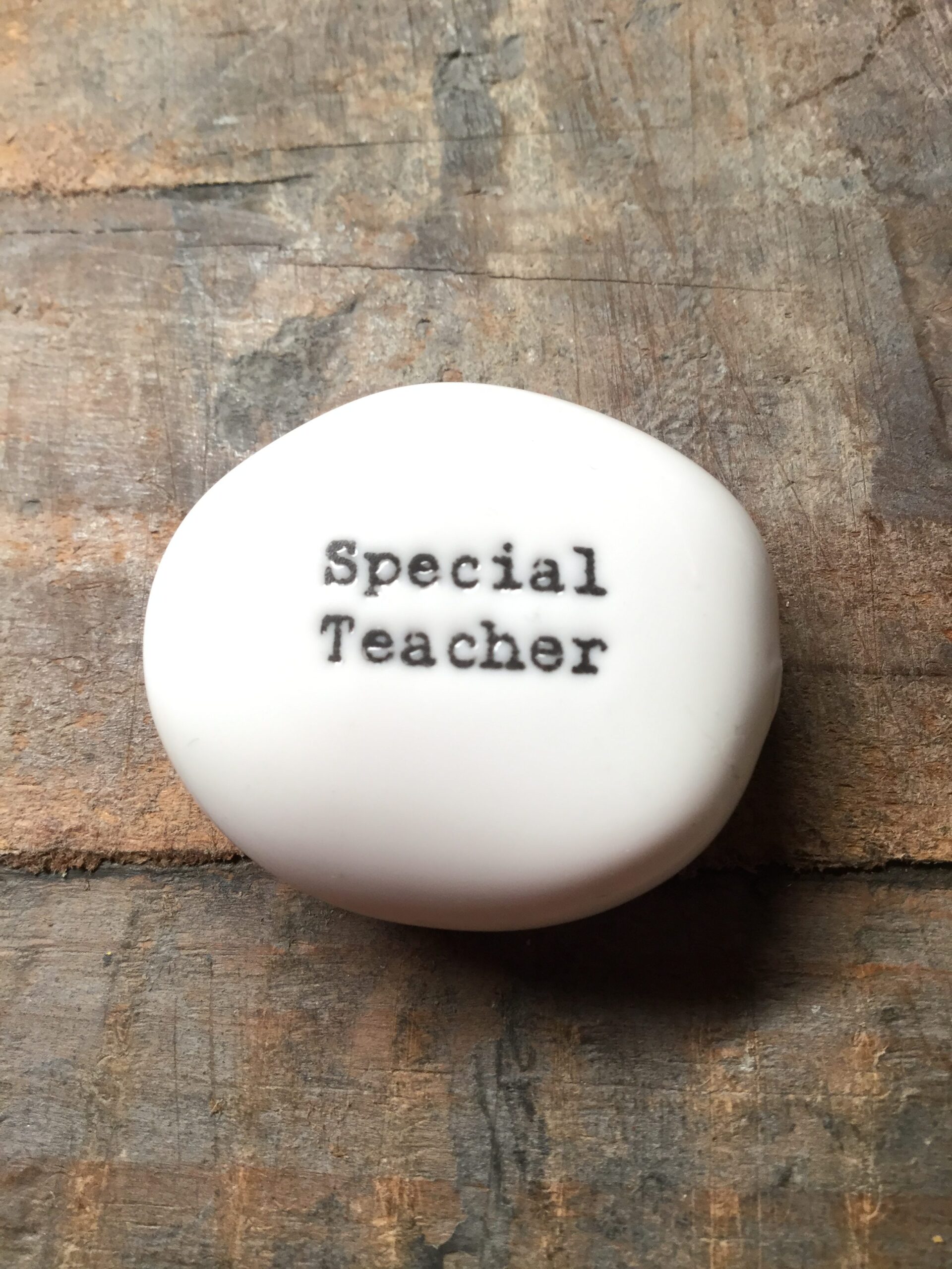 East Of India Small White Porcelain Pebble with Black Type Engraved. Saying: Special Teacher