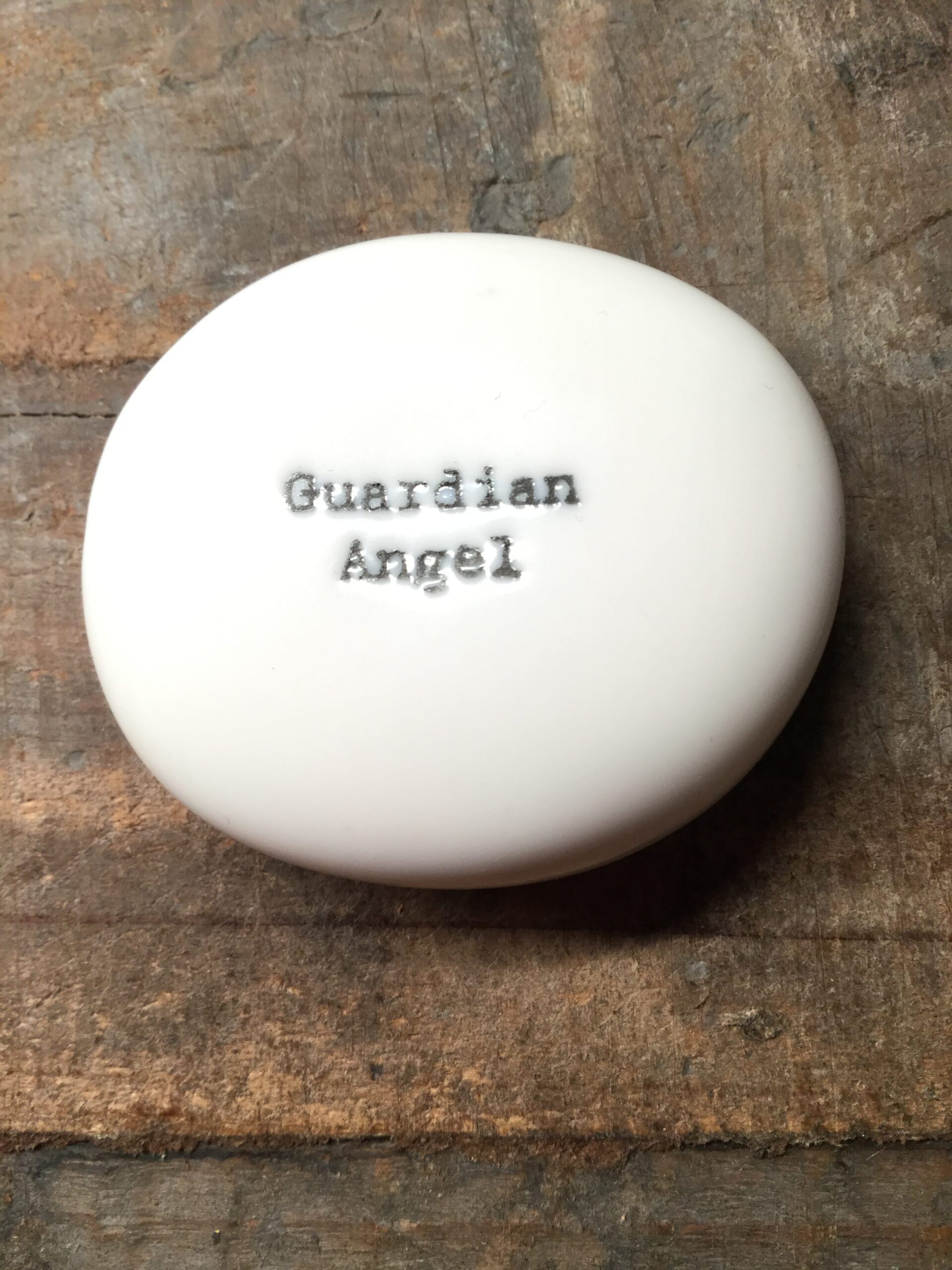 East Of India Small White Porcelain Pebble with Black Type Engraved. Saying: Guardian Angel