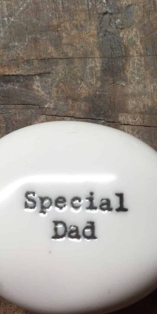 East Of India Small White Porcelain Pebble with Black Type Engraved. Saying: Special Dad