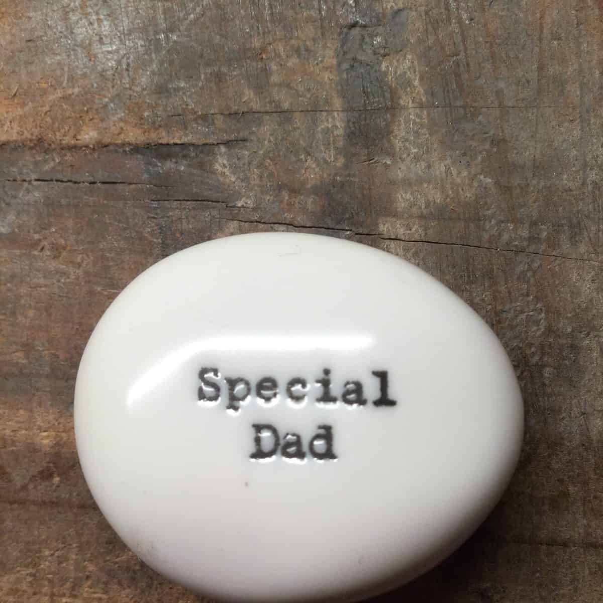 East Of India Small White Porcelain Pebble with Black Type Engraved. Saying: Special Dad