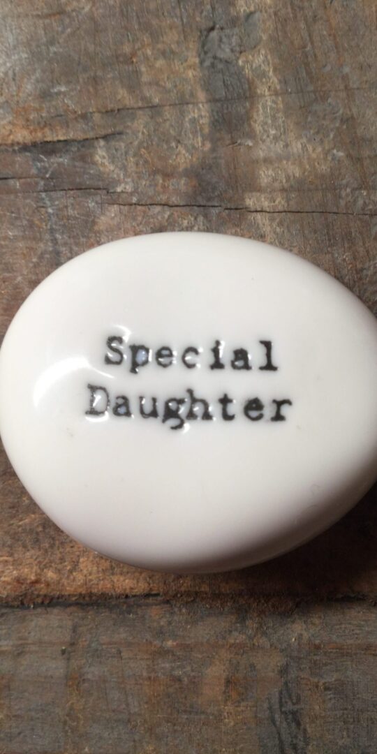 East Of India Small White Porcelain Pebble with Black Type Engraved. Saying: Special Daughter