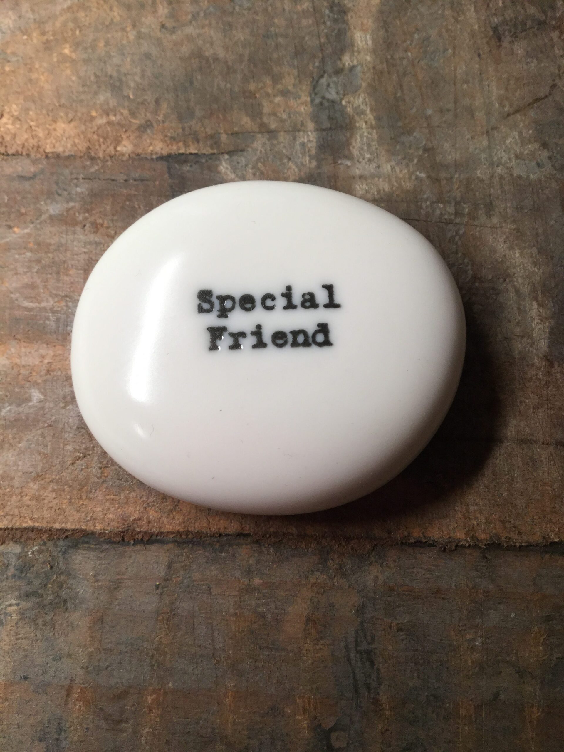 East Of India Small White Porcelain Pebble with Black Type Engraved. Saying: Special Friend