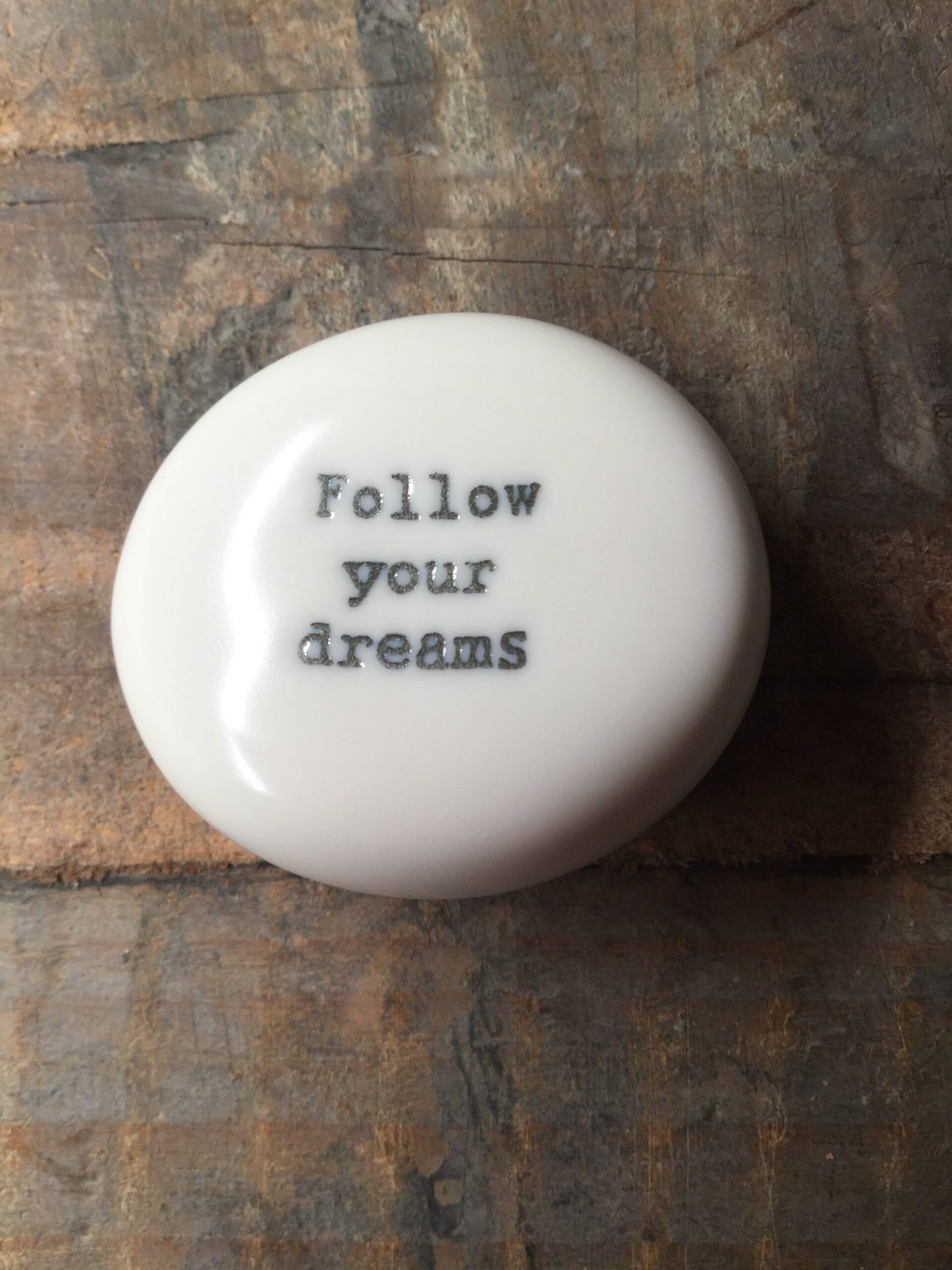 East Of India Small White Porcelain Pebble with Black Type Engraved. Saying: Follow Your Dreams