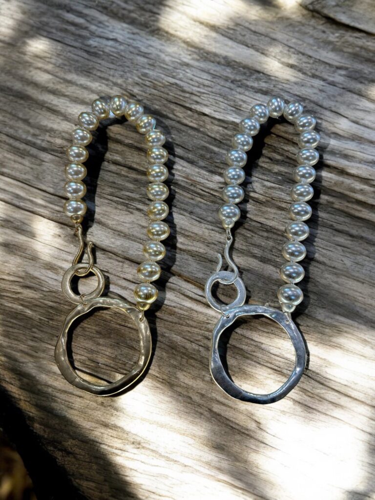 Large pearl style beads necklace closing into two adjoining rings. Silver or Gold.