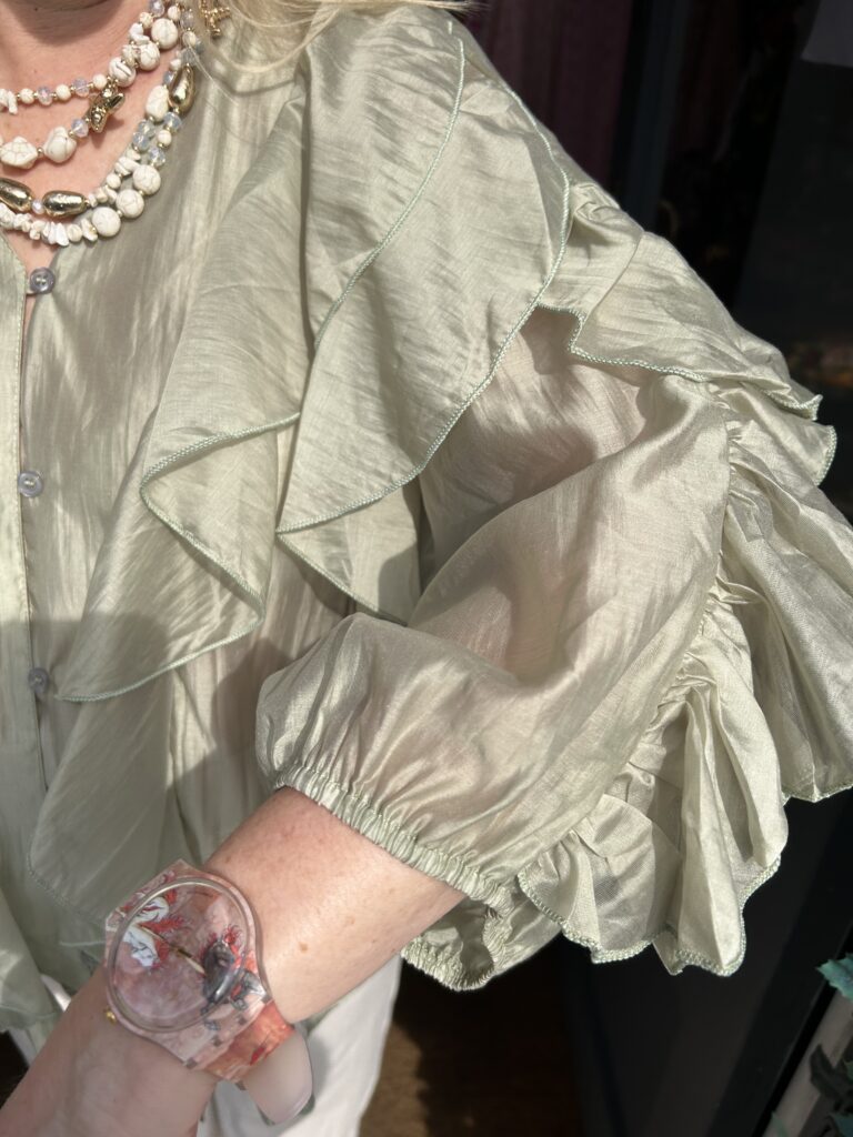 Posie Frill Blouse. Satin like fabric. 3/4 length sleeve. All over front frill.