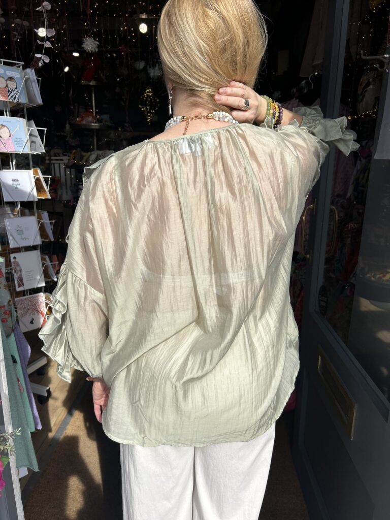Posie Frill Blouse. Satin like fabric. 3/4 length sleeve. All over front frill.