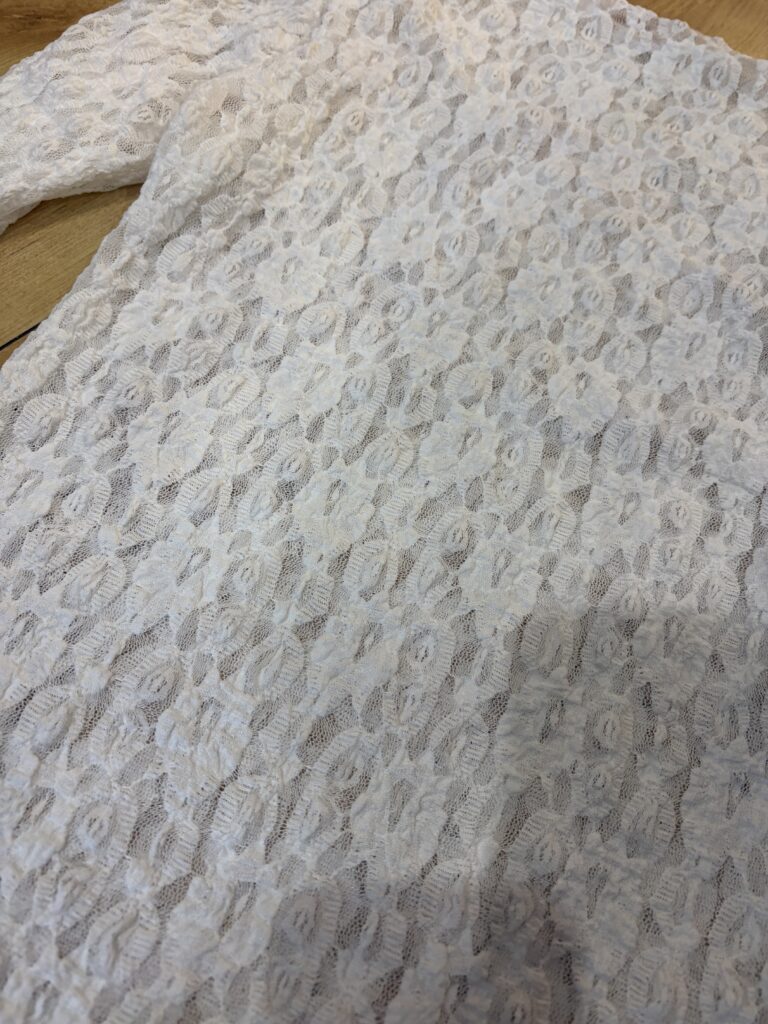 Ola Lace top. Long sleeve. High round neck . Lace detail
