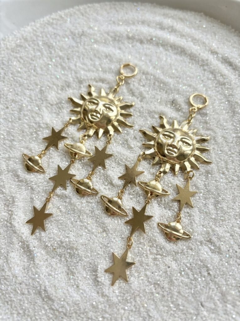 Gold chandelier earrings of sun stars and moons