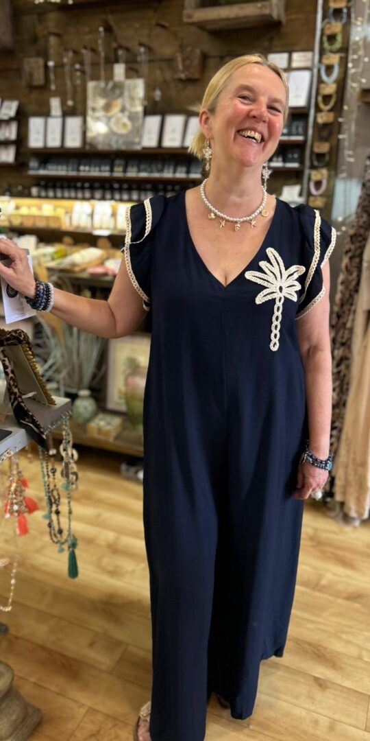 Palm romper suit. Palm embroidery, sleeve detail, tie at the back. Navy.