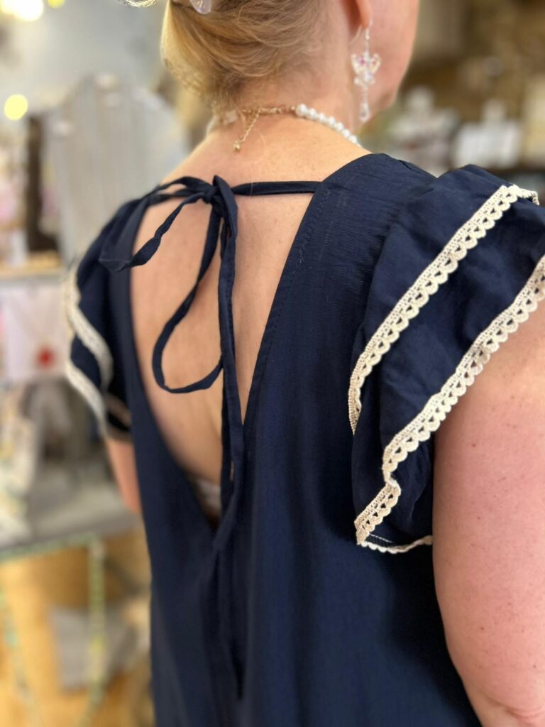Palm romper suit. Palm embroidery, sleeve detail, tie at the back. Navy.