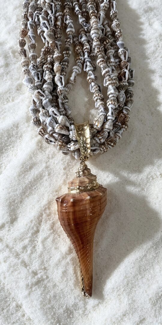 Marisco necklace. Statement big shell and multistrands of tiny shells. Natural